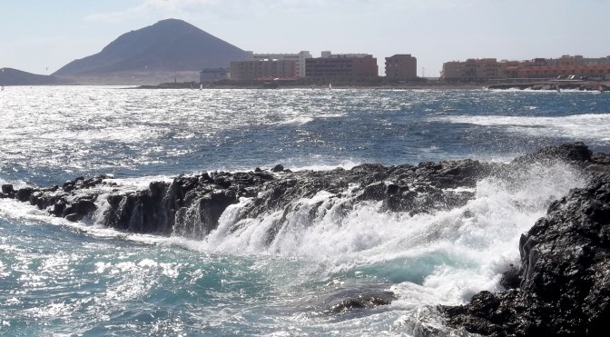 Die Wellen vom Atlantik brechen sich an den Vulkanfelsen von El Medano auf Teneriffa.